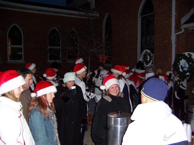 Saline High School Marching Band playing Christmas Carols while Trinity Lutheran Church members pass out free coffee and hot ch